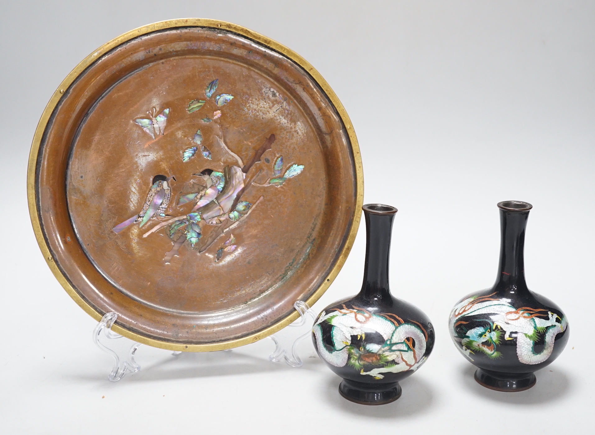 A Japanese bronze abalone inlaid dish and a pair of Japanese cloisonné vases enamelled with dragons, the dish 21cm in diameter